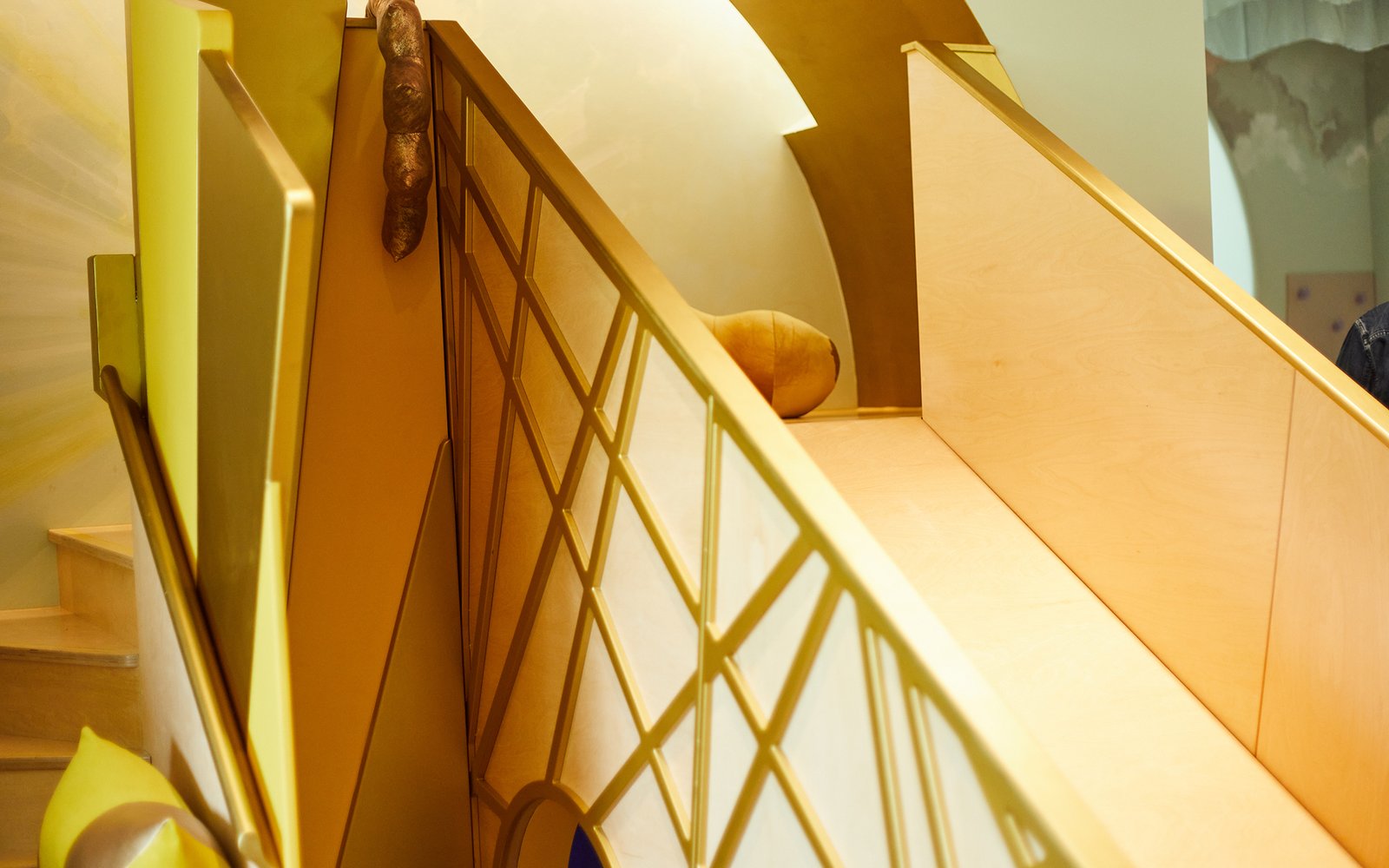 Close up of a wooden slide decorated with gold geometric pattern