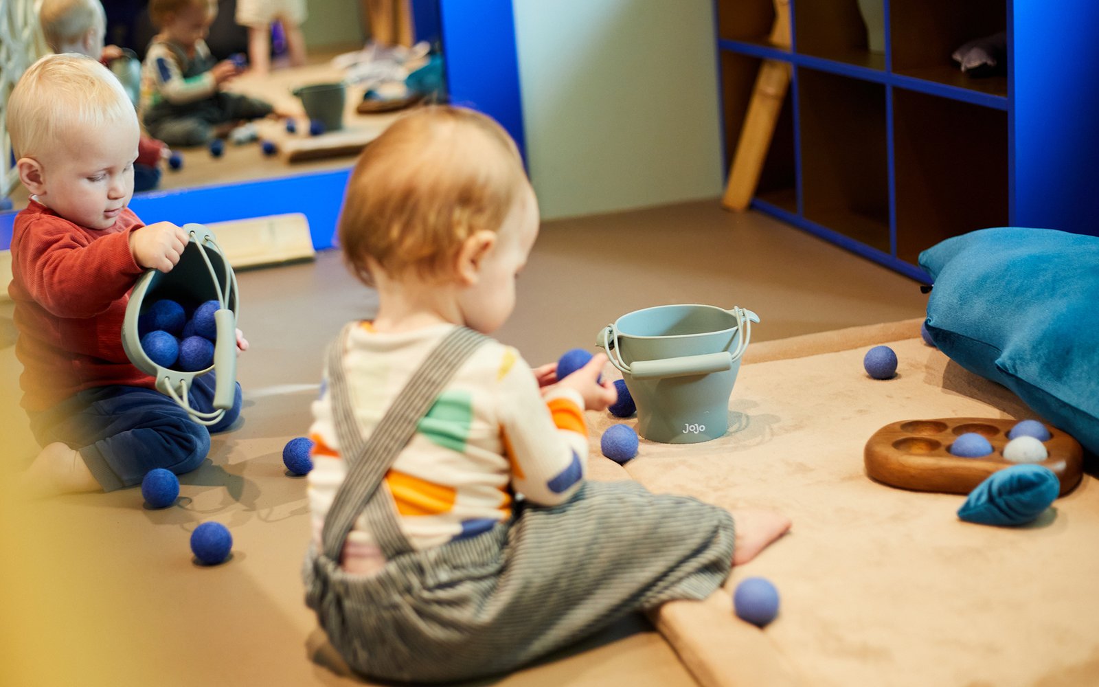 Two babies sat playing with toys