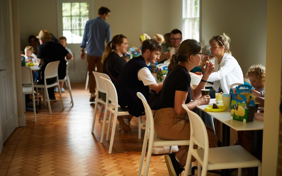 Families with children sat at tables eating