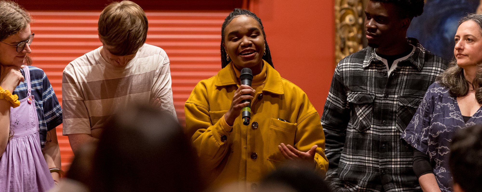 A group of young people singing in the gallery.