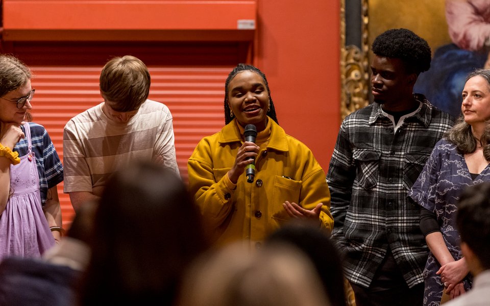 A group of young people singing in the gallery.
