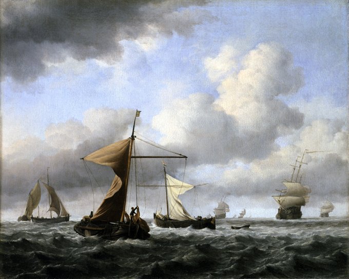Seascape of sailing ships in windy weather with large clouds in a blue sky.