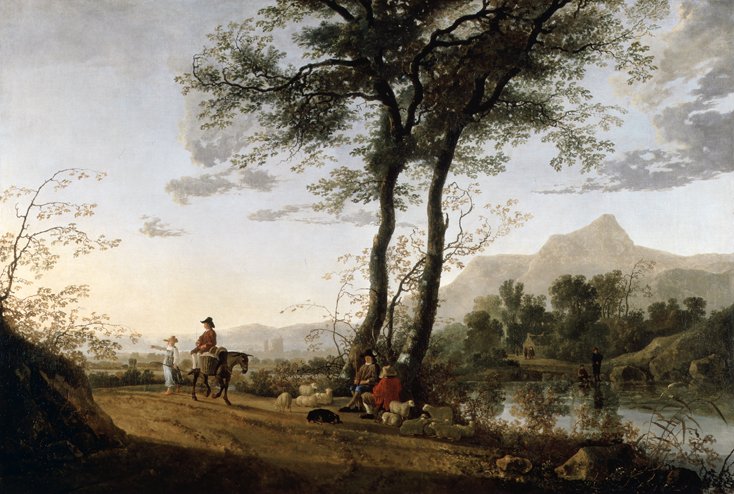 A group of travellers walk along a road next to a river in a mountainous landscape.