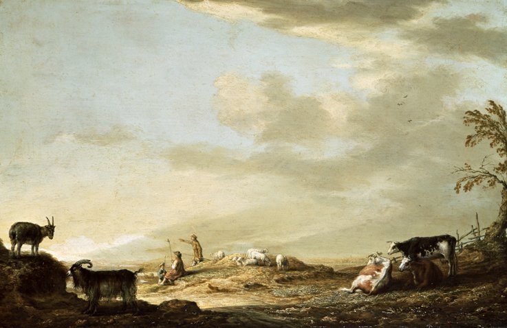 A barren landscape with some cattle, goats and a few people at the centre