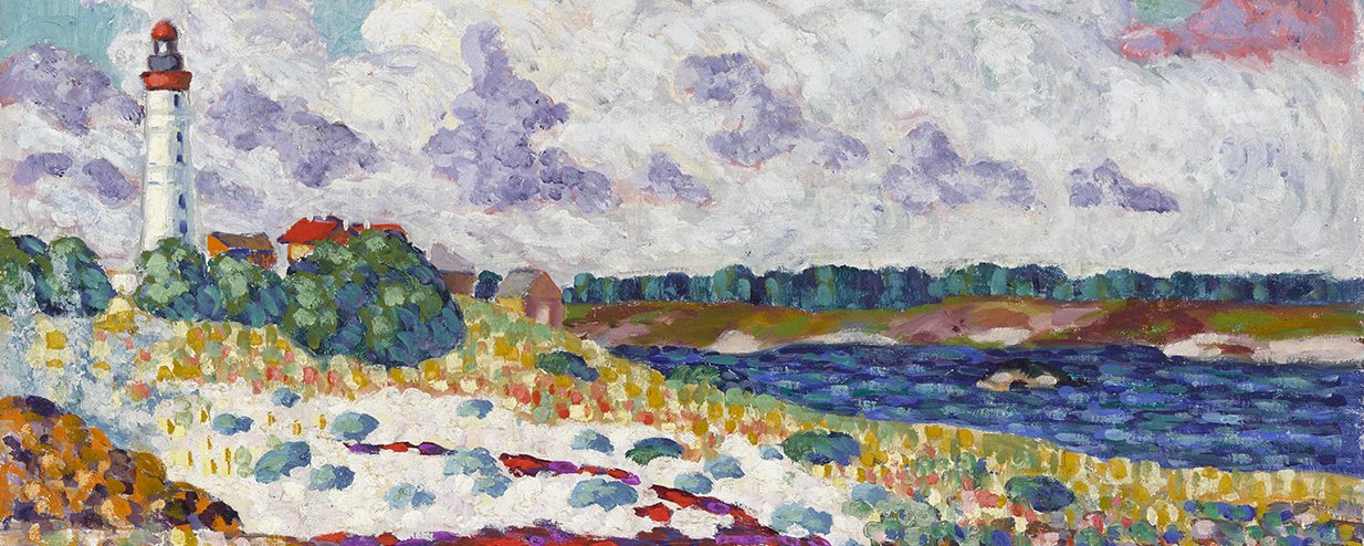 A lighthouse on a rocky shore with a pink sunset behind.