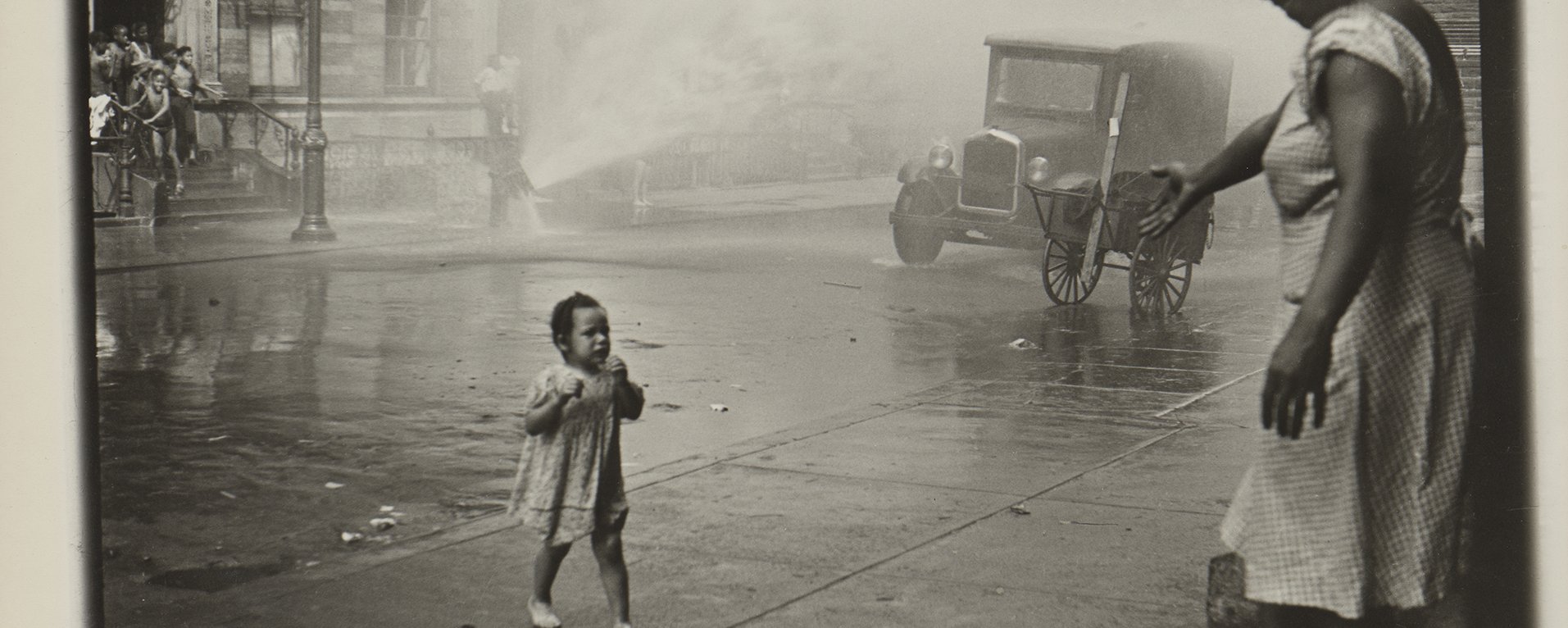 A mother and child in a street in a black and white photo