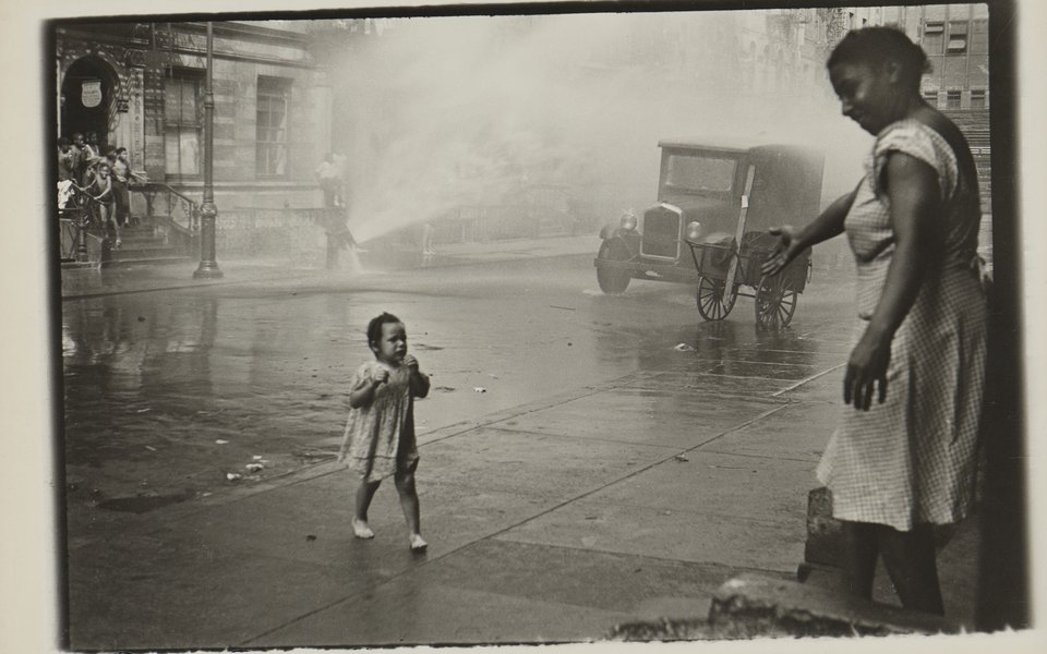 A mother and child in a street in a black and white photo