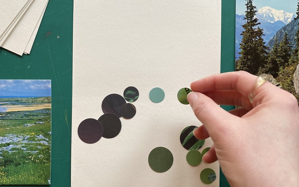 A piece of paper scattered with small circles of different colour paper