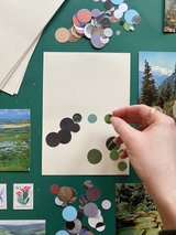 A piece of paper scattered with small circles of different colour paper