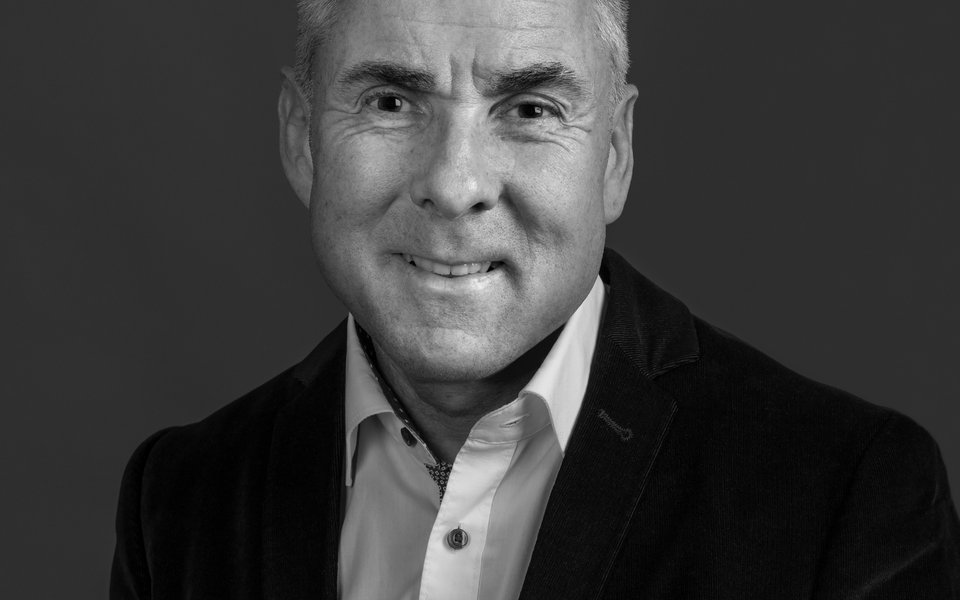 Photograph of a man in a dark suit