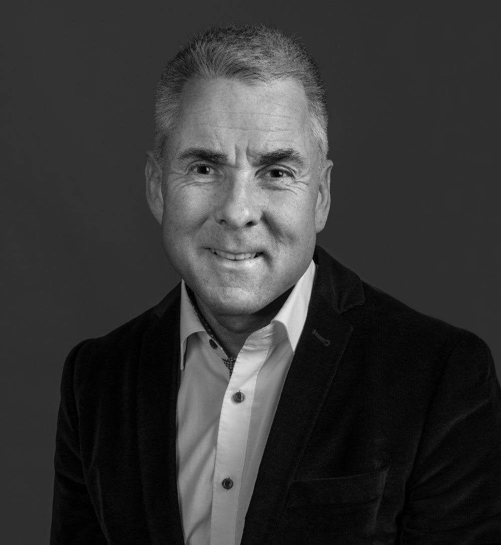 Photograph of a man in a dark suit