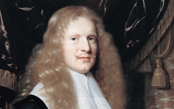 Portrait of a man with long curly blond hair in a white lace rough and sleeves with a deep black doublet over it. He has his left hand on a book next to a human skull.