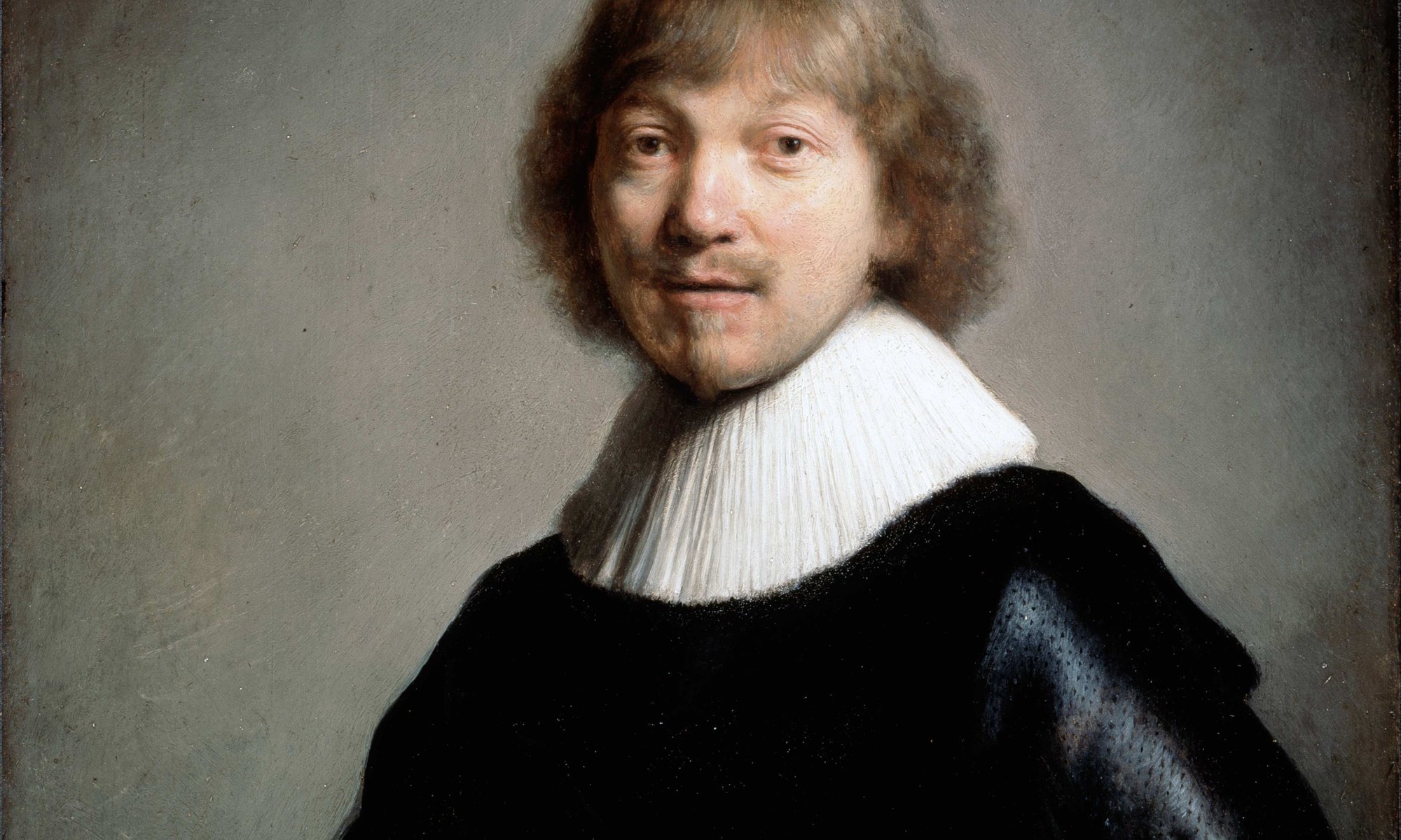 Portrait of a man in a black robe with a large white lace collar on a grey black background. He has longish hair and a goatee beard.