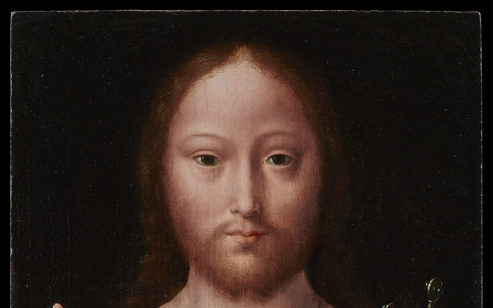 Christ wearing a green robe under a bright red cloak with a gold oval clasp at his neck. His right hand is held up with two fingers extended and in his left hand he holds a reflective globe showing an island city.