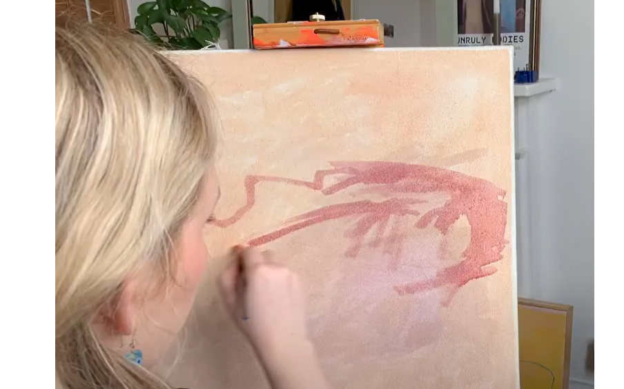 Clip of a woman painting at a canvas.