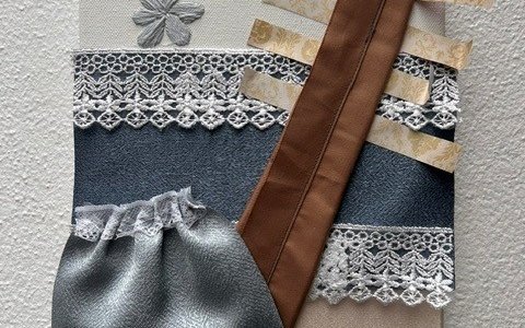 An abstract textile collage work with comb