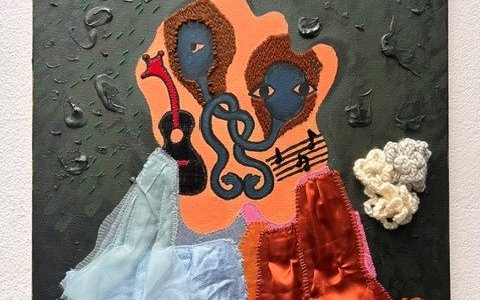An abstract collage piece of paint and textile