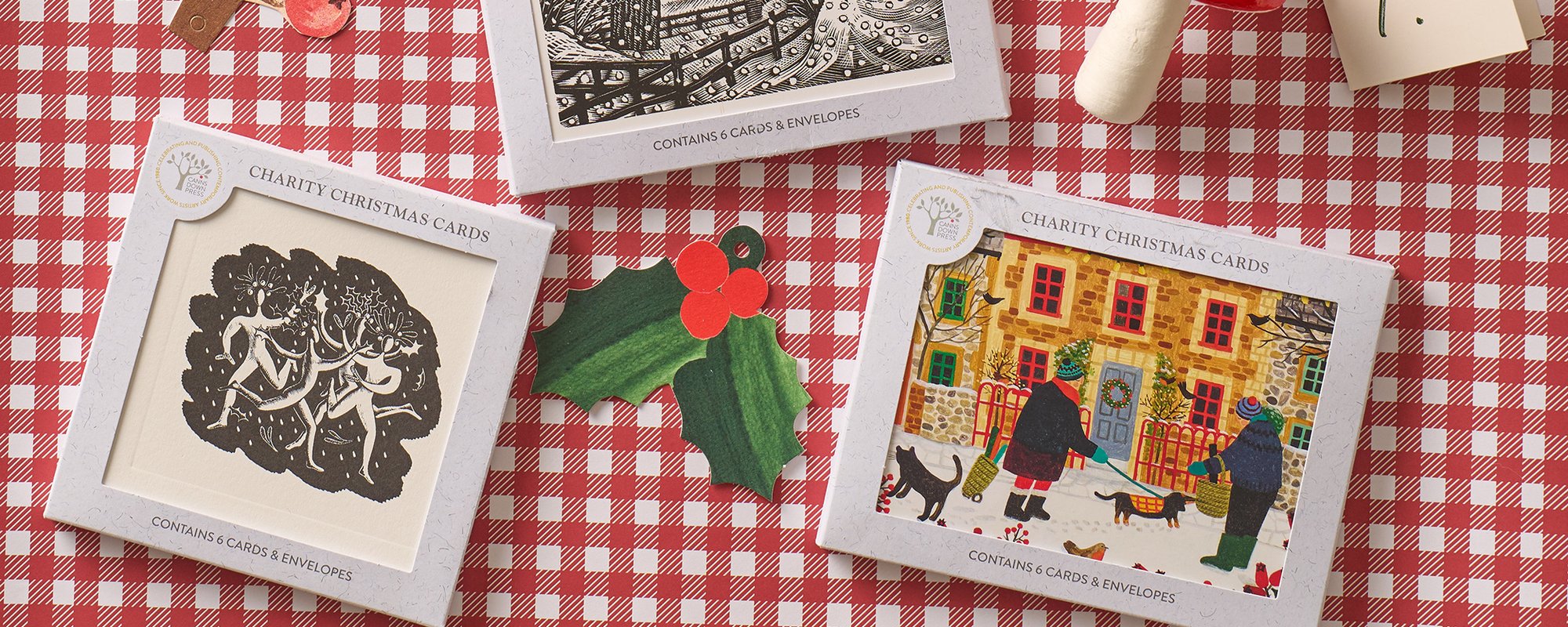 Christmas cards lying on a red and white gingam cloth