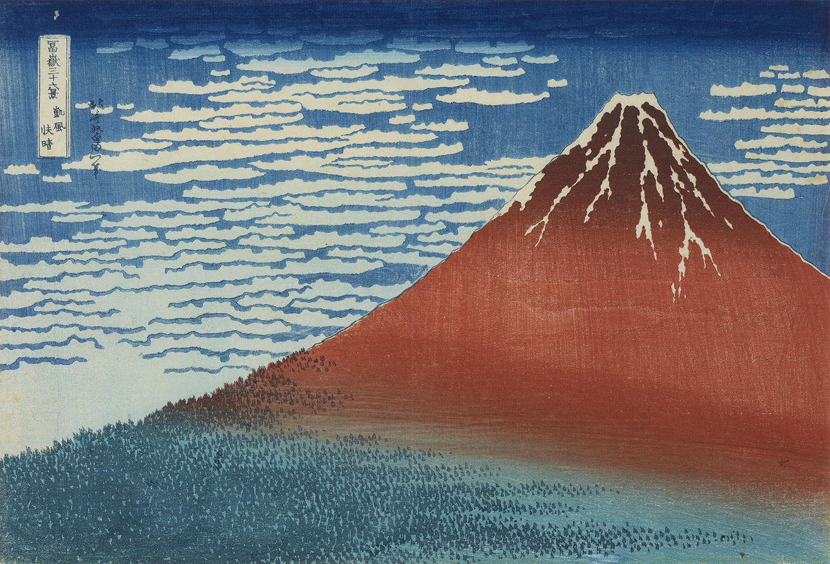 Woodblock print of Mount Fuji in red with snow top with a cloudy sky and trees below.