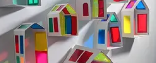 Model houses made with card and coloured plastic for the windows