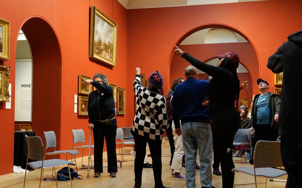 Group of people in a gallery space looking around.